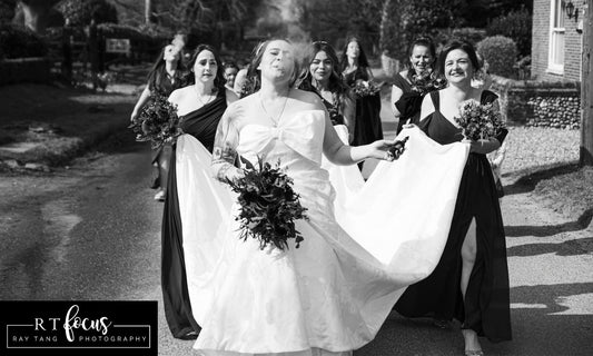 Image of a bride with her bridesmaids, holding a bouquet
