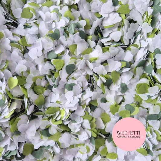 image showing green and white paper confetti in small heart shapes 